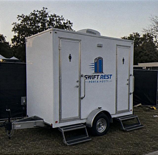 Restroom trailer parked and levelled at an outdoor event